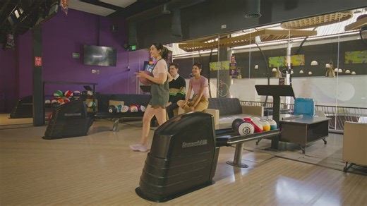 A young woman prepares and makes a bowling shot - Free Stock Video