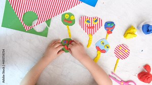 Child modeling craft with fun face. Modeling clay, plasticine and paper crafts idea for kids. Activity in kindergarten and at home. The creative process. Kindergarten and school development