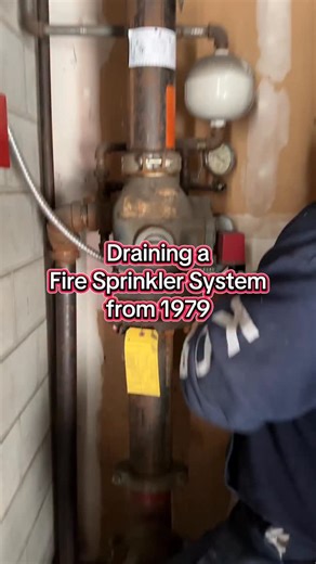Step one of a massive overhaul: draining a system that’s been standing guard since 1979. . This fire sprinkler system, is a perfect example of why consistent maintenance and modern upgrades are non-negotiable for building safety. . You’ll see the original alarm check valve and the vintage retard chamber (the white spherical component) still in place. While this setup has stood the test of time, old systems are prone to internal corrosion and “nuisance” alarms. . Our goal isn’t just to keep these