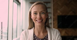 Smiling pleasant blonde woman making hello gesture, starting online web camera call conversation, communicating with colleagues or passing job interview. Beautiful female blogger recording video.