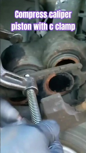 Using a C-clamp and old brakes to compress caliper piston