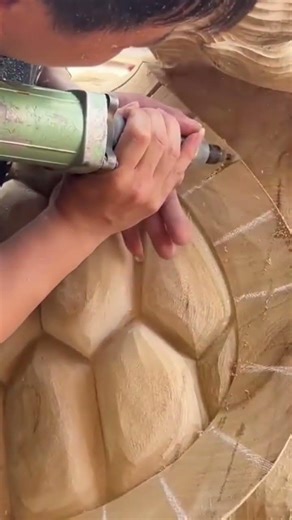 carving intricate patterns on wood using power tool and creating detailed sculpture for decoration