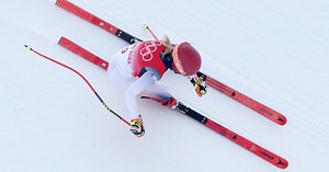 Why are alpine ski poles for speed disciplines curved?