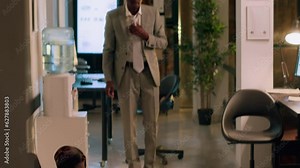 Team leader finishing nightshift, ready to go home, catching tired assistant taking nap on office couch. Manager annoyed by employee slacking off by sleeping in workspace