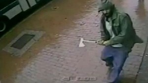 Axe-wielding man attacks New York police – video
