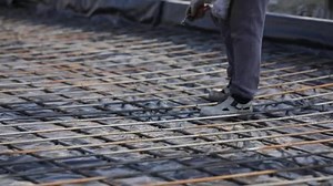 Buildings of logistics center, warehouses in field near the highway, view from height, trucks near the warehouse.