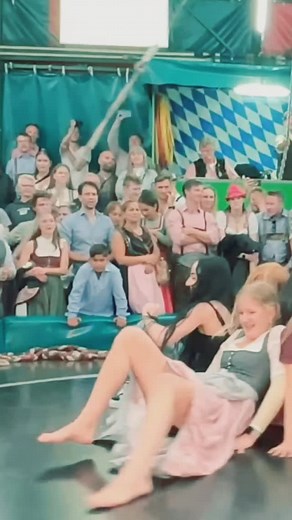 Beautiful Dirndl Girls Tackle Devil's Wheel at Munich Fest #OktoberfestGirls #DevilsWheel #TeufelsradMunich #FestivalVibes #GermanTraditions | Devils Wheel Oktoberfest Fans