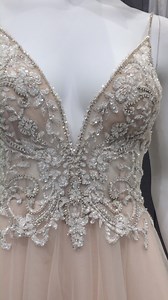 Featuring 5,000 hand-placed crystals, beads, and sequins, the sheer illusion bodice of this flowing organza A-line wedding dress is a sparkling showstopper. Created for brides with a bit of a daring side, this dress also features a plunging V-neckline and back and crystal-traced spaghetti straps. | David's Bridal | Facebook