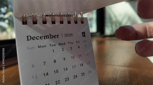 Slow motion footage of flip calendar pages for change months from november to december of the year 2026. concept of planning and starting a new month. 4k horizontal.