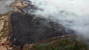Aerial view burning at landfill site cause smoke