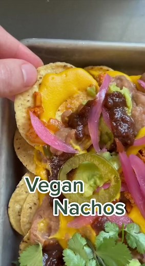 Nachos are the ultimate crowd-pleaser. These vegan nachos are sure to thrill vegetarians, vegans, and meat-eaters alike with creamy queso, sofritas, beans, salsa, and guacamole. They’re easy to customize, too. Full recipe: https://bit.ly/3XjyoYc | Simply Recipes