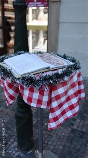 Vertical screen restaurant menu on outdoor stand with prices visible showing rising dining costs and inflation pressure as people reconsider eating out in city