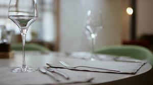 The waiter serves the table in the cafe. Video from the restaurant. The waiter straightens the knife on the table. Table setting. Preparing the restaurant for the opening. modern restaurant