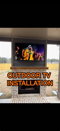 SYLVOX OUTDOOR TV MOUNTED OVER A FIREPLACE ON A BACKYARD PATIO. THIS TV IS MADE TO HANDLE EXTREME WEATHER CONDITIONS. WE CAN INSTALL THESE AND MUCH MORE. YES, WE INSTALL TVS IN COMMERCIAL (BUSINESS) BUILDINGS AS WELL. WE’RE THE NUMBER ONE RATED TV MOUNTING COMPANY IN OR NEAR ATLANTA WITH 520 ⭐️⭐️⭐️⭐️⭐️5 STAR REVIEWS. WE INSTALL TVS, FLOATING SHELVES, SOUNDBARS, GAMING CONSOLES, LED LIGHTS, ELECTRIC FIREPLACES, MANTLE MOUNTS, CABLE BOXES, PICTURES, MIRRORS, ELECTRICAL OUTLETS, LIGHT FIXTURES, ACC