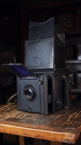 The Houghton-Butcher Popular Pressman Peflex was a medium format single-lens reflex (SLR) camera manufactured in the United Kingdom by Houghton-Butcher Manufacturing Co. in the early 20th century. It was designed for professional and press use, notable for its robust and reliable construction. It used photographic plates and a reflex system with a folding mirror for direct focusing. It incorporated a folding hood-type viewfinder and interchangeable lenses, which was advanced for its time. It is 