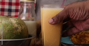 Southeast Asa wood apple bael fruit Limonia acidissima hard shell half inside flesh made juice drink ingredients