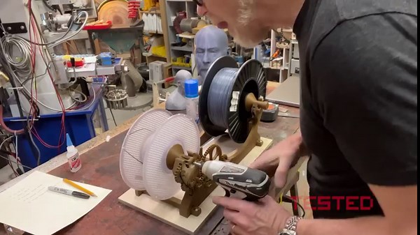 Adam upgrades his 3D print farm with a filament winder and then he redesigns the printer stand to accommodate a massive filament waste chute. Do you hand a print farm? Full video on YouTube; link in bio! #3dprinting #printfarm #adamsavage #maker | Tested