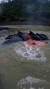 Sudden Underwater Eruption – First-Person Amateur Footage Handheld POV along the riverbank. Small geyser-like bursts erupt from submerged lava formations, glowing red-orange beneath water. Follow for more Earth Impacts #earthimpacts #veo3 #sora #kling #ai | Earth Impacts