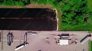 Hopper grain trailer semi truck on a scale to check gross weight of equipment. Top down aerial in Wisconsin