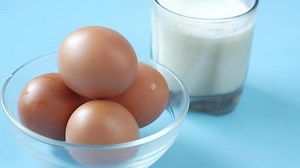 Eggs and milk on a blue background