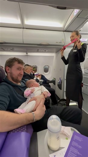 Three-month-old baby fascinated by safety briefing in Moscow, Russia