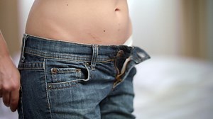 Slim woman taking off jeans from hips | Free Stock Video Footage