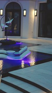 Is Modern Zen more your style? Award-winning Modern pool in Jupiter, Florida with an infinity edge, Ledge Loungers, in pool fire feature, custom sculpture, and a knife edge. A knife edge pool has water that sits at the same level as the pool deck to create a mirror surface effect. #modern #lucaslagoons #insanepools #pooldesign #poolbuilder #poolside #knifeedgepool | Lucas Lagoons