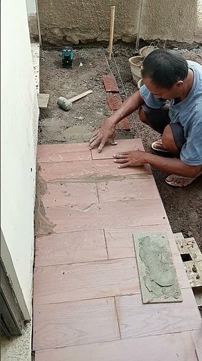 Installing wood-patterned ceramic tiles.
