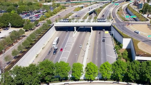 An aerial shot of busy Interstate 71 in Columbus, Ohio, capturing heavy traffic, multiple lanes, and the surrounding urban landscape and highways. Stock Video