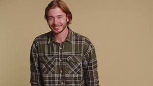 Smiling playful happy man blinking eye, looking at camera with toothy smile, winking and flirting