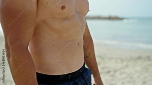 Young man tourist wearing swimsuit standing at the beach Stock Video