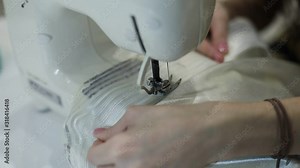 Process of sewing the curtains at home, close up of curtain tape on the sewing machine, hemming, tailoring, repairing and stitching cloth and dress, with the hand of female dressmaker in background Stock Video