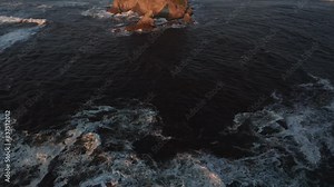 Flight over waves and Little James Island at sunset, Rialto beach. Dolly in aerial
