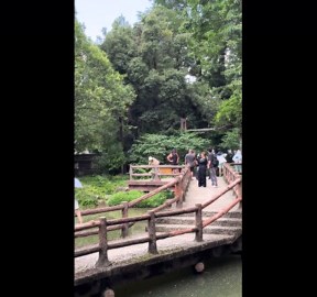 Woman shouts to trigger manually operated fountain in Hangzhou, China