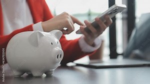 saving money and accounting concept. business man putting coin insert to jar and make acounting book for finance management to investment and saving.