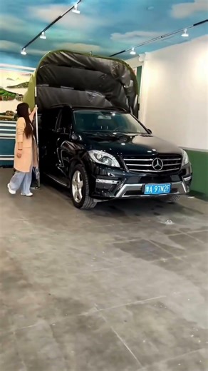 A stainless steel and Oxford fabric car shelter that folds automatically