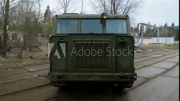 The exterior of a mid-20th century medium-track artillery tractor, designed for towing trailers, transporting people, and cargo.