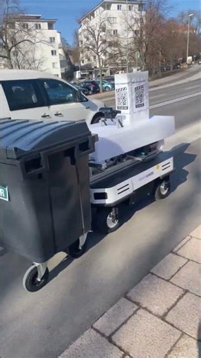 Robot Hauls Trash Bin Down the Street