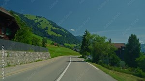 Driving on mountain road in alpine valley in Switzerland. Driving in the swiss alps. Filmed from the drivers point of view and the car. Traveling in beautiful alpine nature in Switzerland, Europe. Pov
