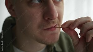 Oral hygiene with a toothpick. A person uses a toothpick to remove leftover food from his mouth. Wooden toothpick