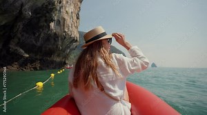 Woman sitting on boat passing lagoon. Back view female travel, riding on gondola, sitting on ship bow and looking enjoy beautiful nature in a wicker hat in summer day. Tourism, positive relax concept.