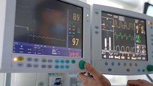 clip-1080840923-medical-monitors-operating-room-doctor-changes-data