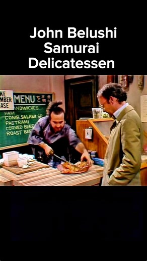 John Belushi’s Samurai Delicatessen with Buck Henry | SNL Classic One of the sketches that defined early Saturday Night Live: John Belushi’s “Samurai Delicatessen” (1975). Belushi’s over-the-top Samurai character slices through sandwiches, walls, and anything in sight—while Buck Henry plays the straight man, the unlucky customer just trying to order lunch. The contrast between Belushi’s wild physical comedy and Henry’s deadpan reactions made the sketch a timeless SNL moment. This was the birth o