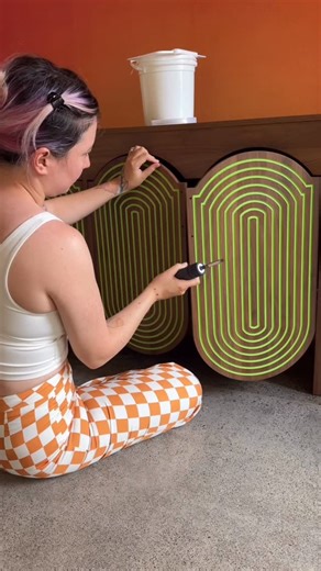 Tay BeepBoop Nakamoto on Instagram: "The 70’s sunset living room 🌅 I changed the hardware that came with the cabinet so it’s a lot more seamless (original ones were thick black handles!!). Did a layer of primer and used a blade to scrape off the excess but found it’s a better use of time to just be messy, layer on the colored paint on top of primer, then just peel and roll the excess off (surprisingly this came off cleaner than using a blade), then finish with isopropyl alcohol to clean up fine