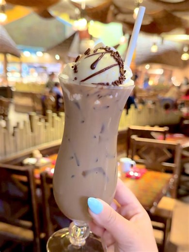 Disney Food Blog on Instagram: "☕🦓 Zebra Dome Cold Brew at Boma Breakfast — $18.50 If you’re a Zebra Dome fan, this one’s going to get your attention. This cold brew cocktail blends cold brew coffee, Amarula cream liqueur, Mozart chocolate liqueur, whipped cream, and—yes—a WHOLE Zebra Dome on top. Let’s start with the obvious: the Zebra Dome is exactly what you want it to be. Moussy, light, chocolatey with that subtle white chocolate vibe, a thin icing on top, and the shortbread base add