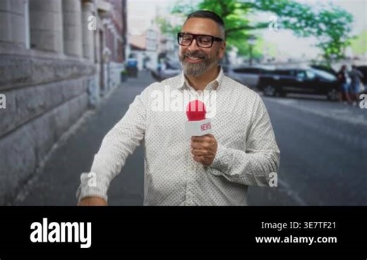 Man reporter holds red microphone on street, smiling and gesturing with his hand while facing camera; confidence professionalism Stock Video Footage - Alamy