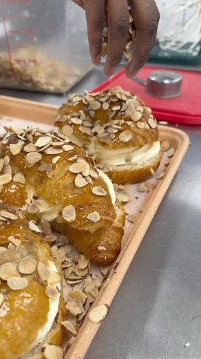 Buttery and flaky on the outside, fluffy on the inside, and loaded with creamy almond goodness! 🥐✨ Who else feels like they’re biting into a slice of heaven with every bite of this almond croissant? 😋 Drop a 🥐 in the comments if you’re ready to indulge in some pastry perfection! | The Ambrosia Bakery