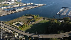 Aerial / drone reveal footage of Smith Cove Cruise Terminal 90 and Elliot Bay , Interbay and Magnolia, upscale, affluent neighborhoods uptown by Puget Sound, in Seattle, Washington