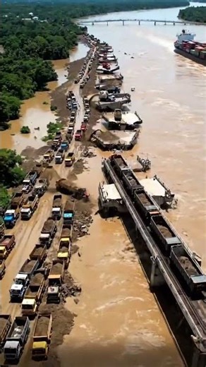 A massive, powerful water vortex is spinning directly below the broken bridge edge