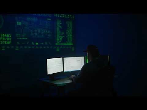 VideoVault Stock Video: Hacker who wants to crack a code on a computer